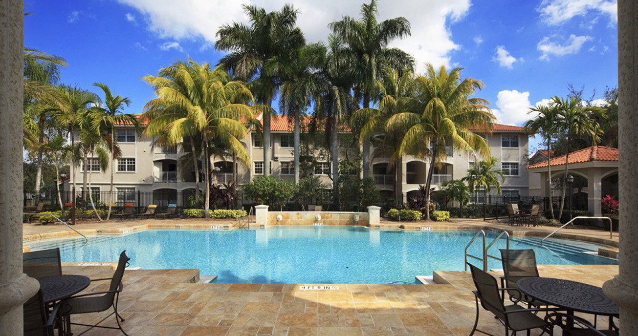 outdoor pool with apartment building and palm trees, marquesa, pembroke pines fl